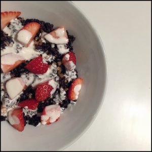Black rice topped with fresh strawberries and thick cashew milk