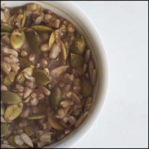 Overnight oats in black bean/honey puree topped with pepitas and sunflower seeds