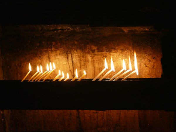 Candles lit outside Christ's tomb in the Church of the Holy Sepulchre